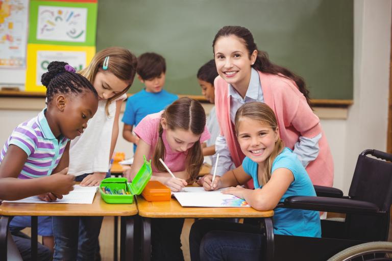 children working at a table in a classroom