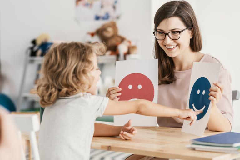 Child choosing a happy face visual